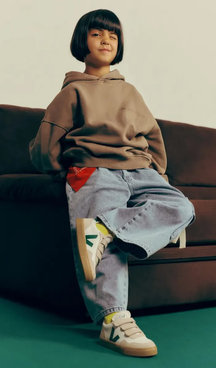 Four kids wearing Veja sneakers